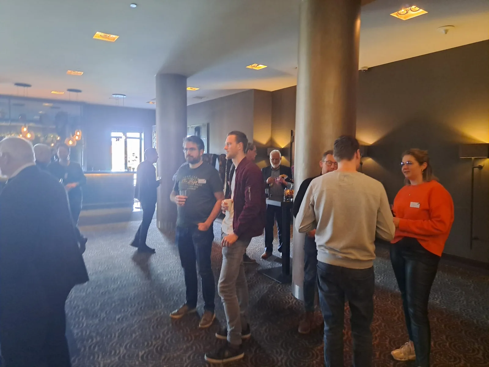 Visitors talking over a drink in the lobby of a hotel